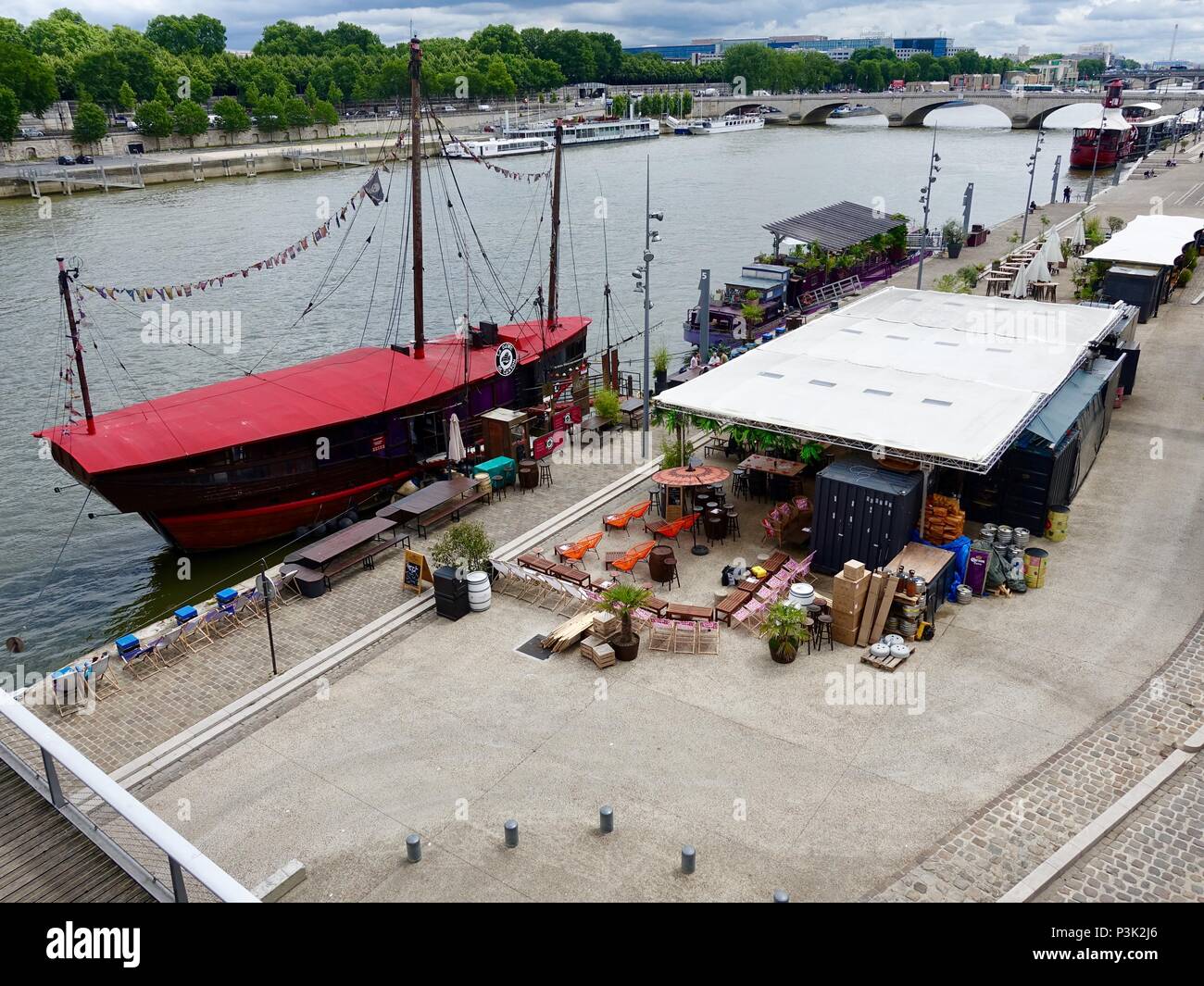 Floating bars and restaurants with outdoor seating areas along the