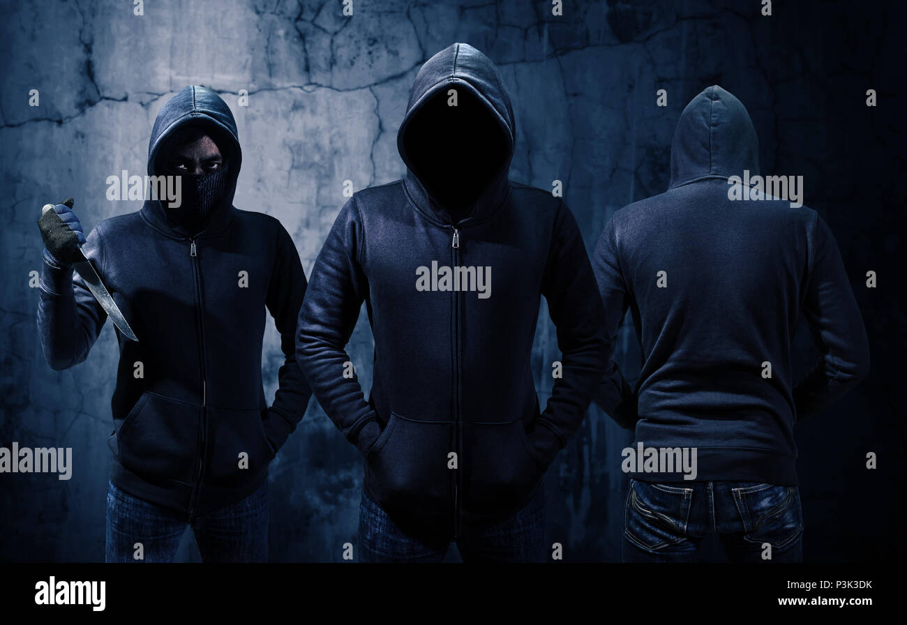 Gang of robbers or burglars dressed in black Stock Photo
