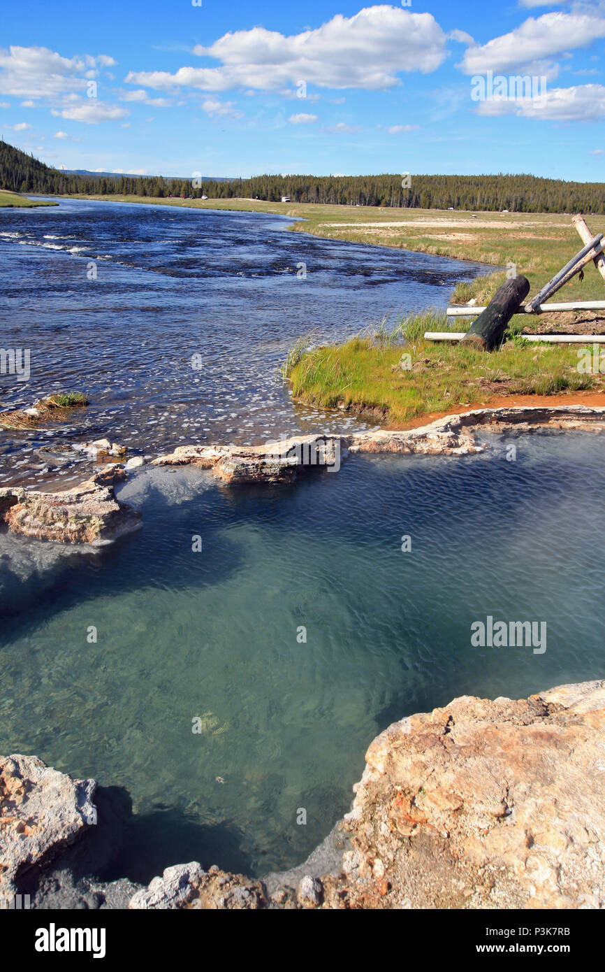 Maidens Grave Hot Spring flowing into the Firehole River in Yellowstone National Park in Wyoming United States Stock Photo