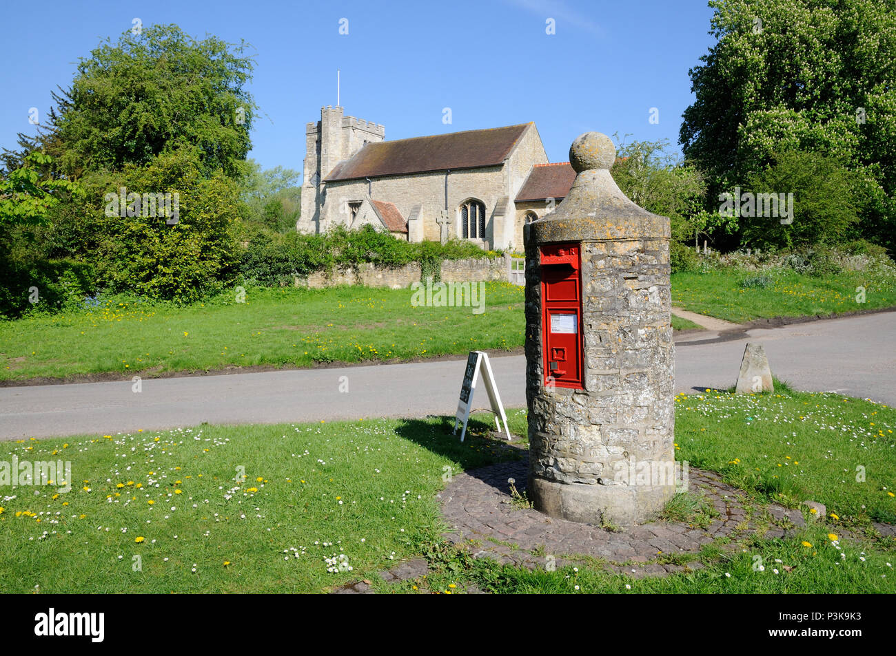 This unique Pillar Box at Nether Winchendon, Buckinghamshire, dating from 1850, stands on a circle of bricks, on a small triangular green . Stock Photo