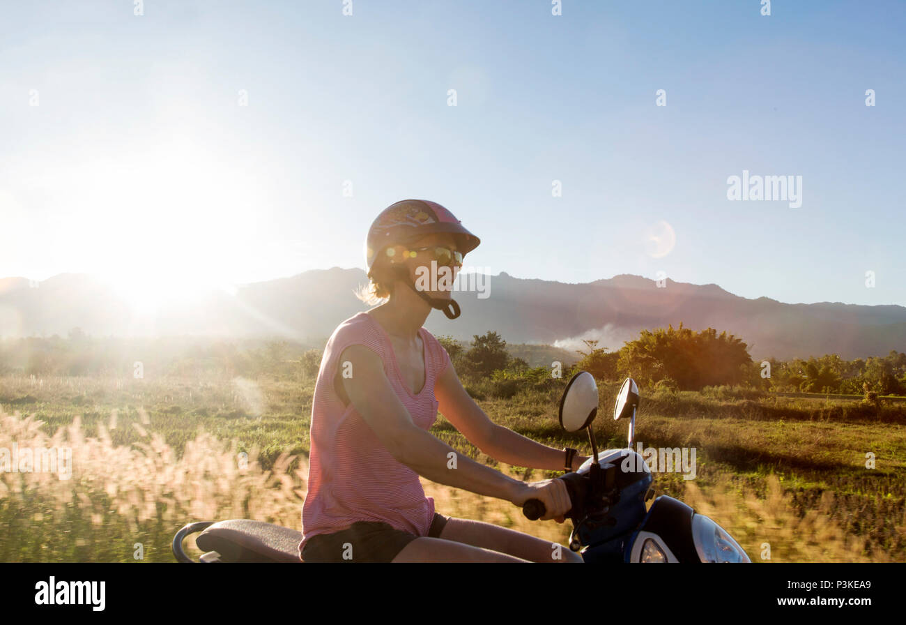 Adult woman riding scooter, Pai, Mae Hong Soon, Thailand Stock Photo