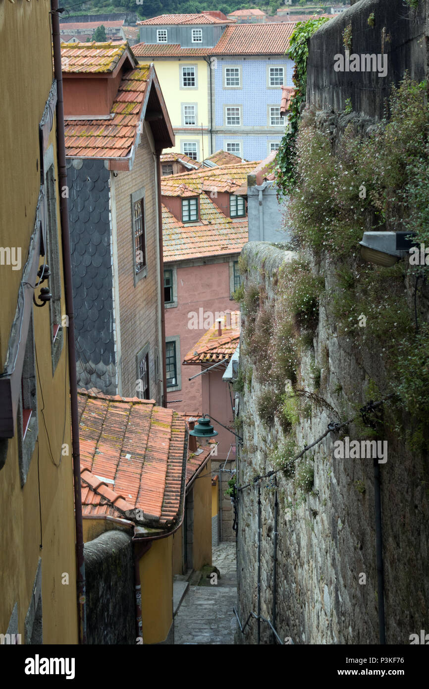 The narrow, winding streets between houses in the Ribiera district of Porto, Portugal Stock Photo