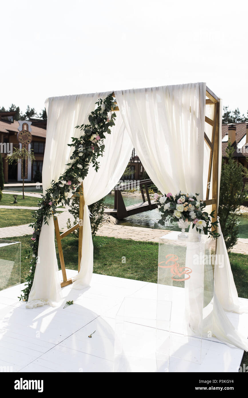Beautiful wedding ceremony outdoors. Square wedding arch Stock Photo