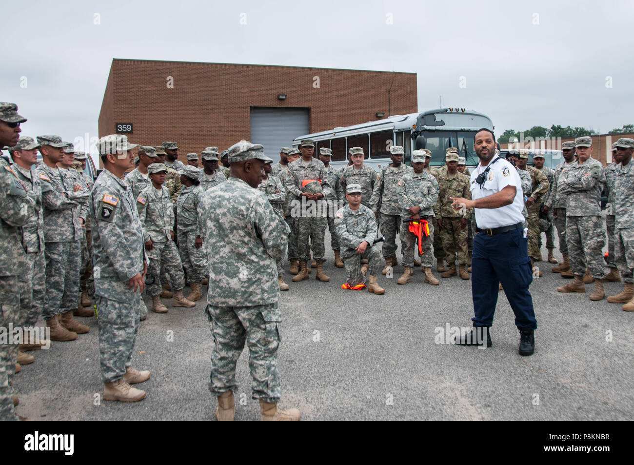 Soldiers assigned to the 104th Maintenance Company, District of Columbia Army National Guard, or DCNG, receive a brief about traffic control procedures given by a member of the District Department of Transportation, or DDOT, July 4 at Joint Base Anacostia-Bolling. About 300 DCNG Guardsmen were deputized by the Metropolitan Police Department to augment local law enforcement agencies during the Independence Day festivities in the District. (U.S. Army National Guard photo by Staff Sgt. Aimee Fujikawa/Released) Stock Photo