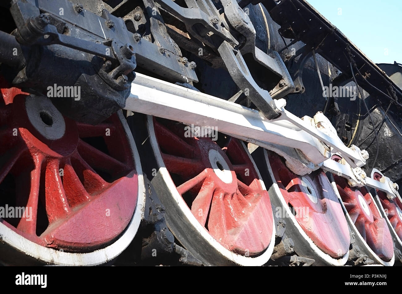 Red wheels of old USSR black steam locomotive. Wheels of an old soviet ...