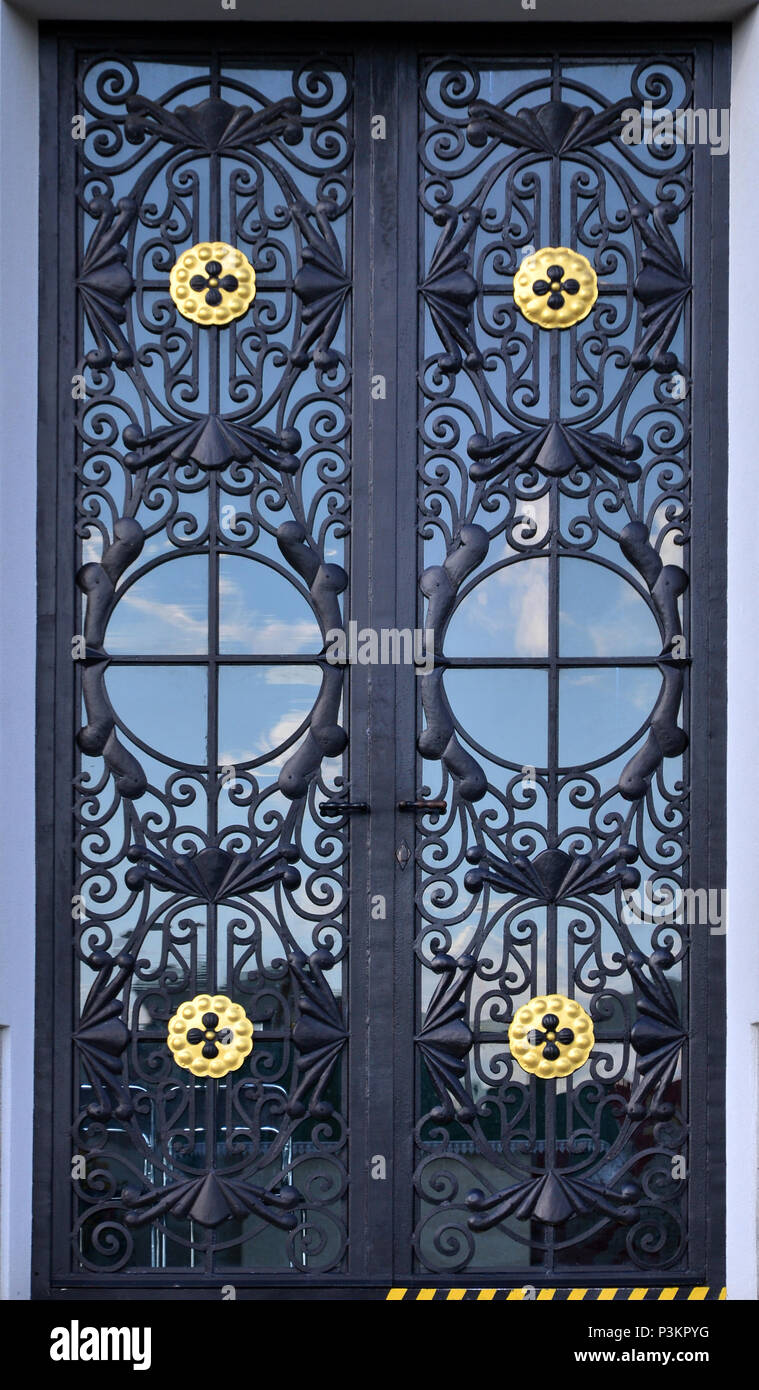 The texture of the modern metal door is black. Outdoor view Stock Photo