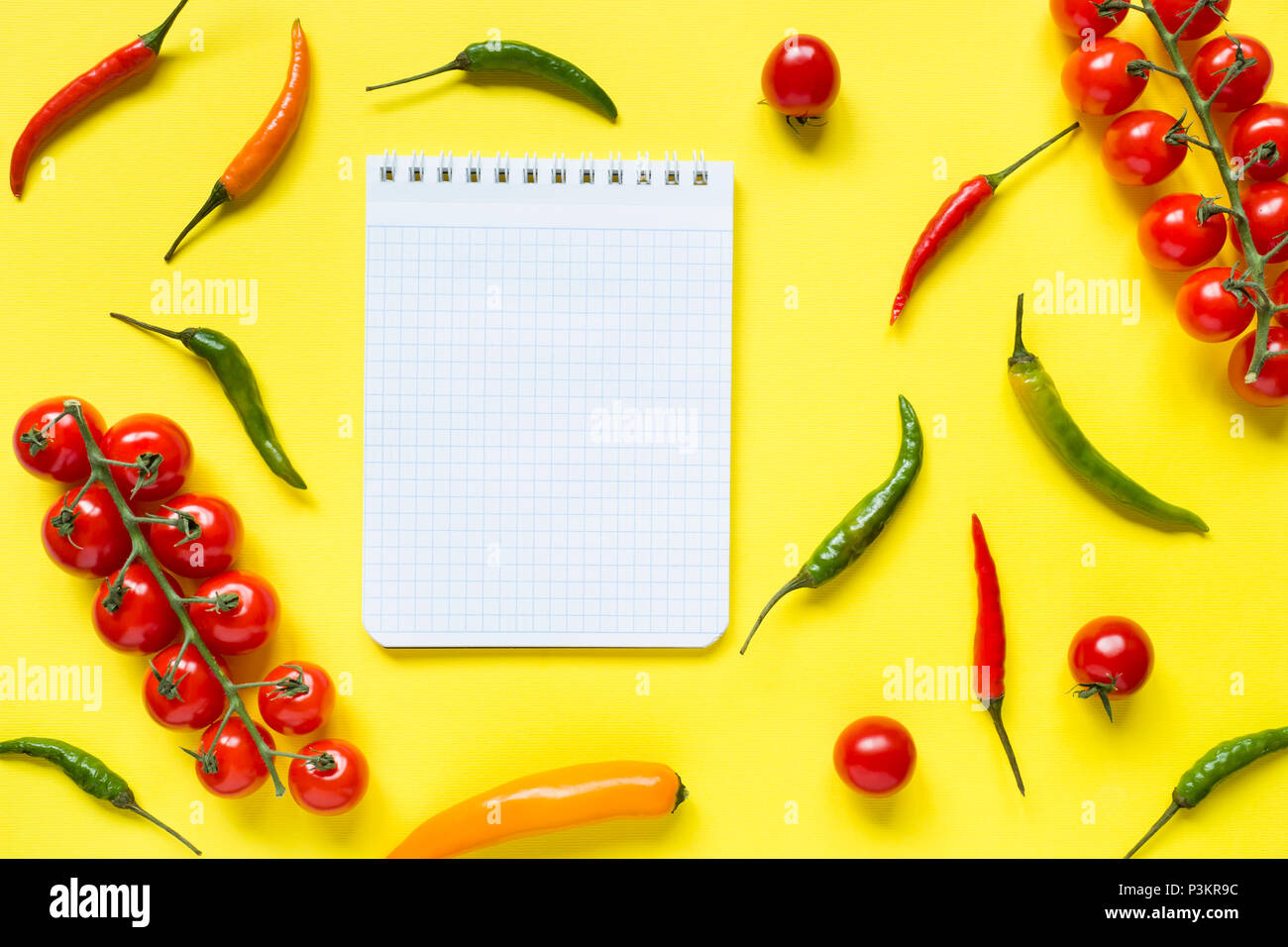 Assorted chili pepper tomato cherry On yellow bright background. Stock Photo