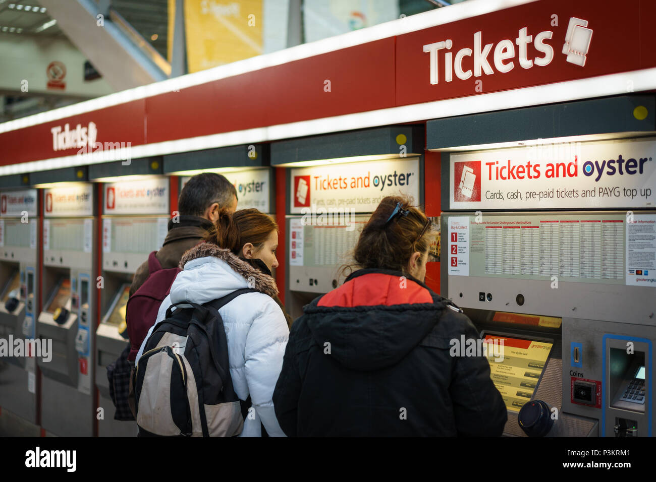 London, UK - November 2017. Tourists and commuters at tickets machines in Liverpool Street Station, one of the busiest stations in London. Stock Photo