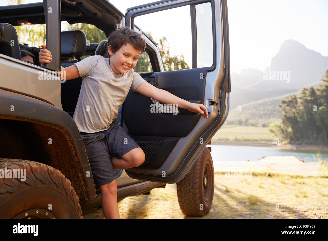 Children Get Out Of Car After Reaching Lake On Road Trip Drive Stock