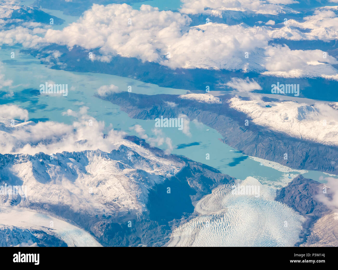 View from aeroplane window of snow covered Andes mountains with lakes, glacier tongues and icebergs, Southern Patagonian Ice field, Patagonia, Chile Stock Photo