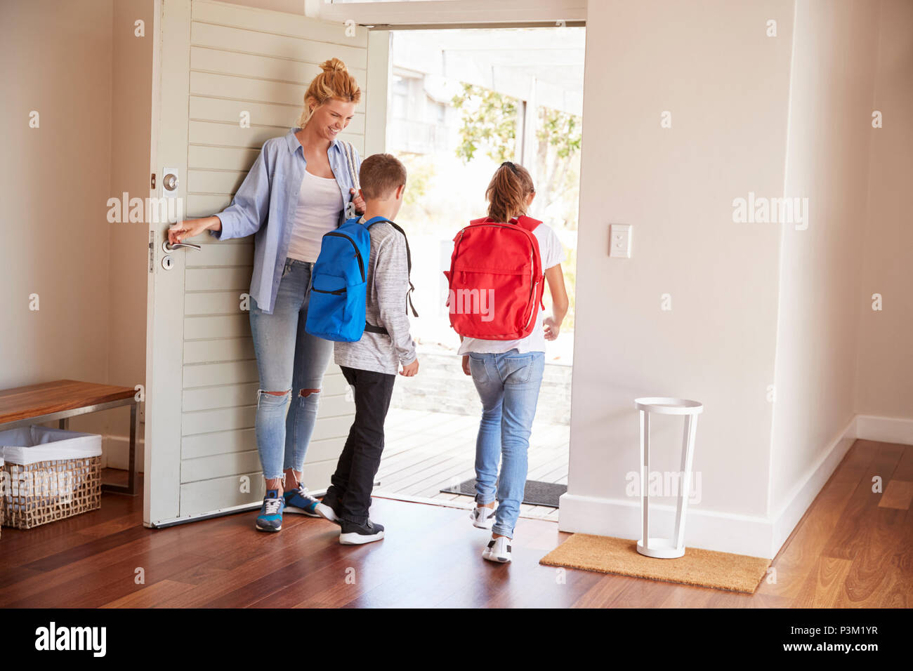 Mother Getting Children Ready To Leave House For School Stock Photo Alamy