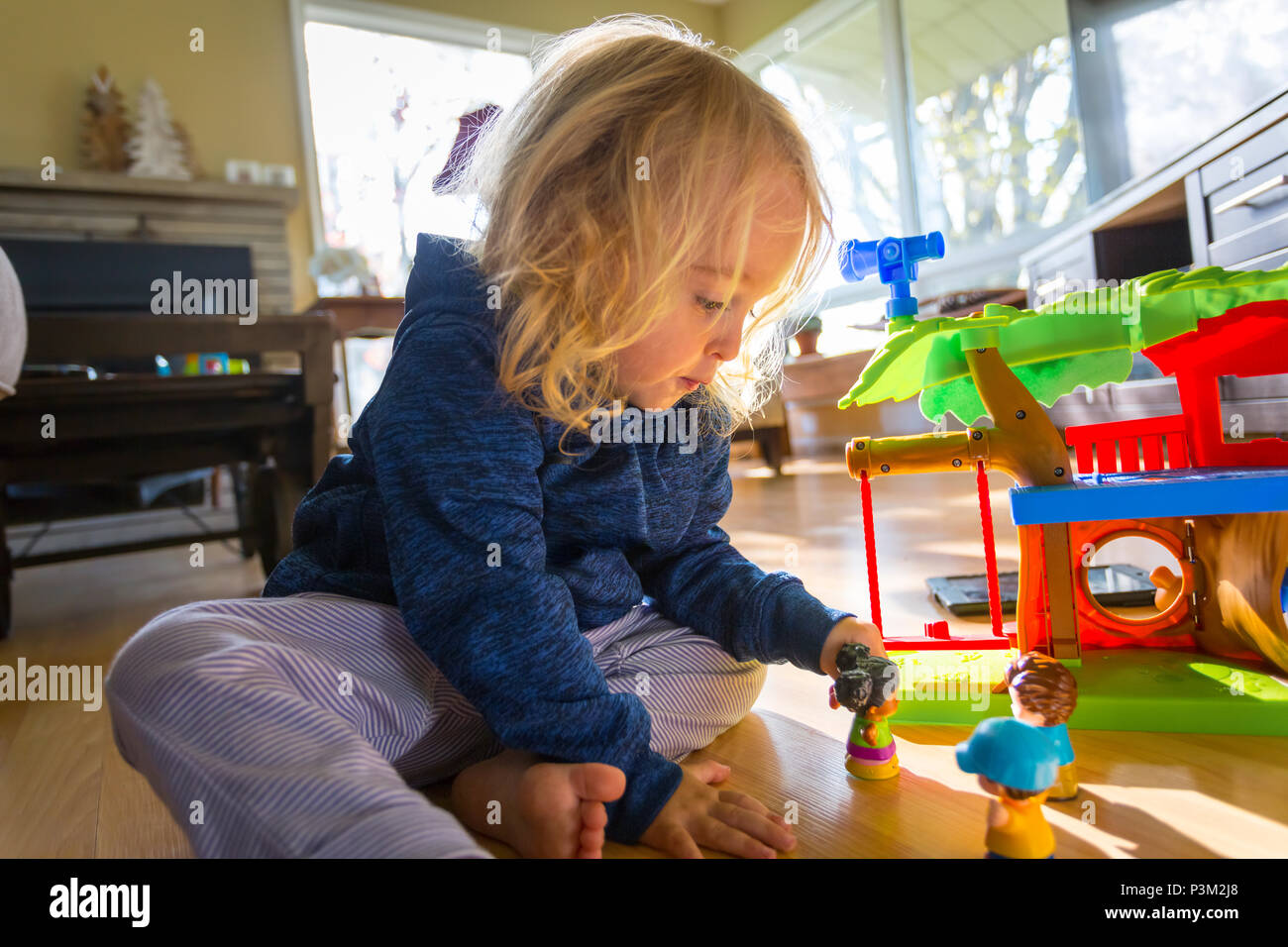 2 year old girl playing with dolls Stock Photo