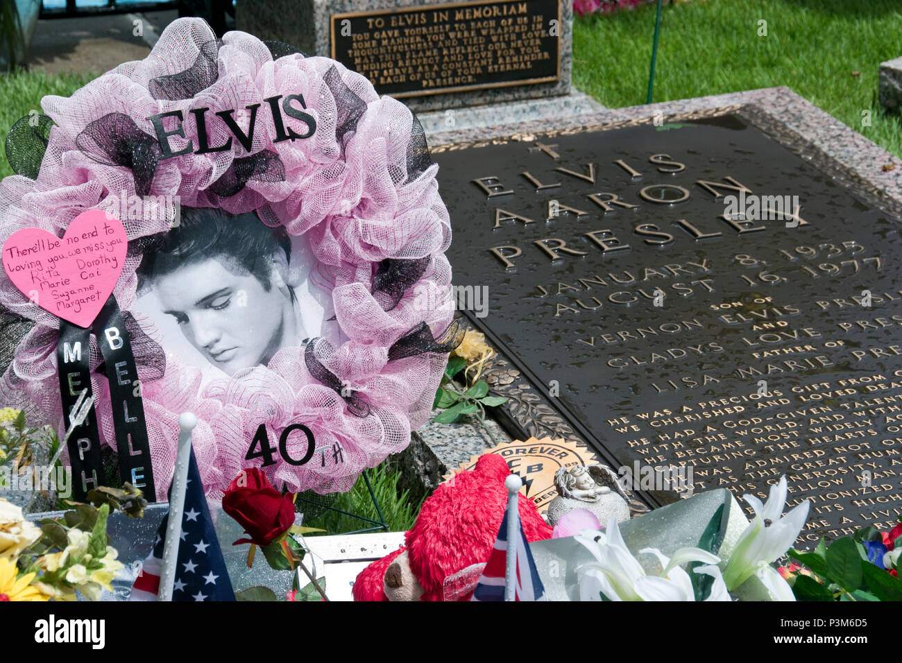 Elvis Presley’s grave, surrounded by flowers and tributes on the 40th