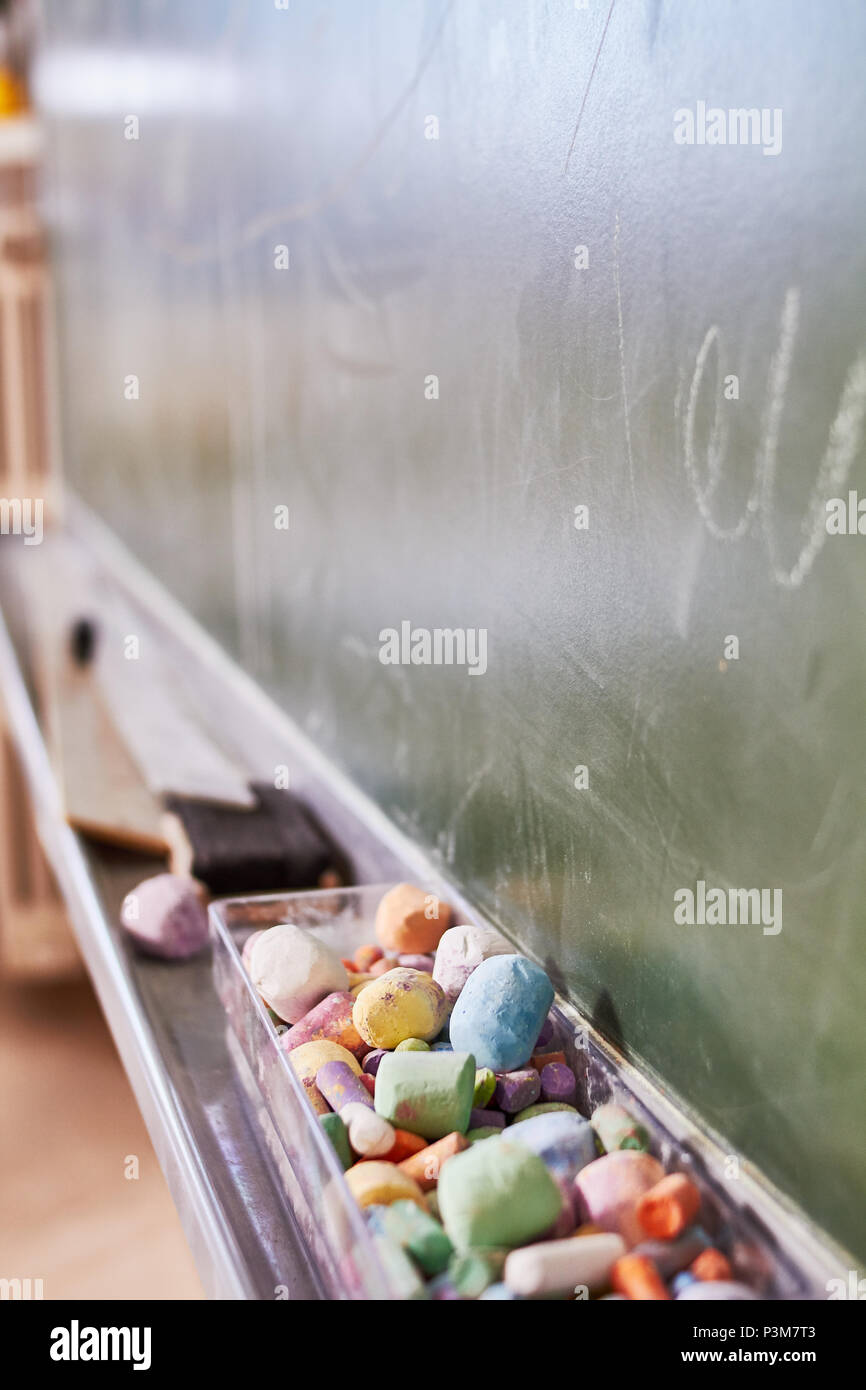 Some old color chalk in a dusty blackboard Stock Photo