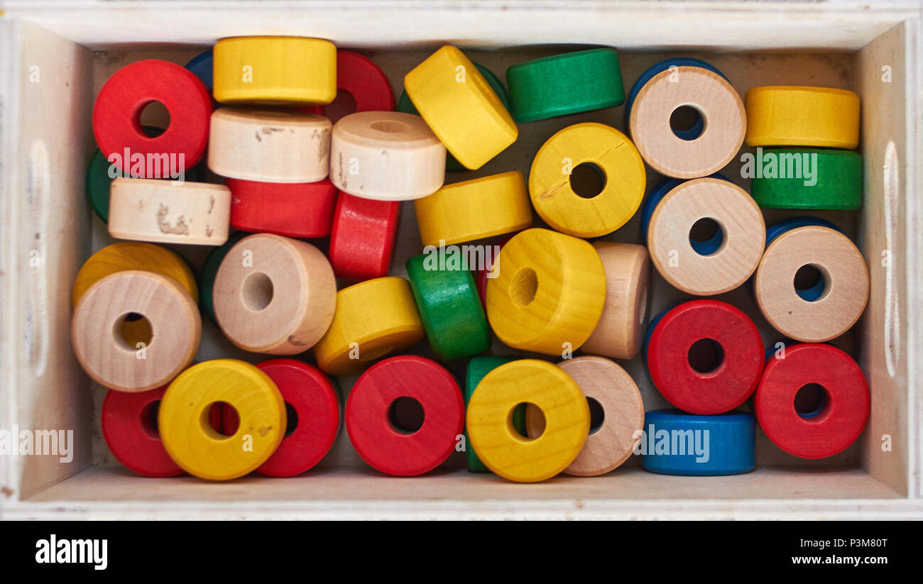 Set of colorful wooden cylinders for sewing at school Stock Photo Alamy