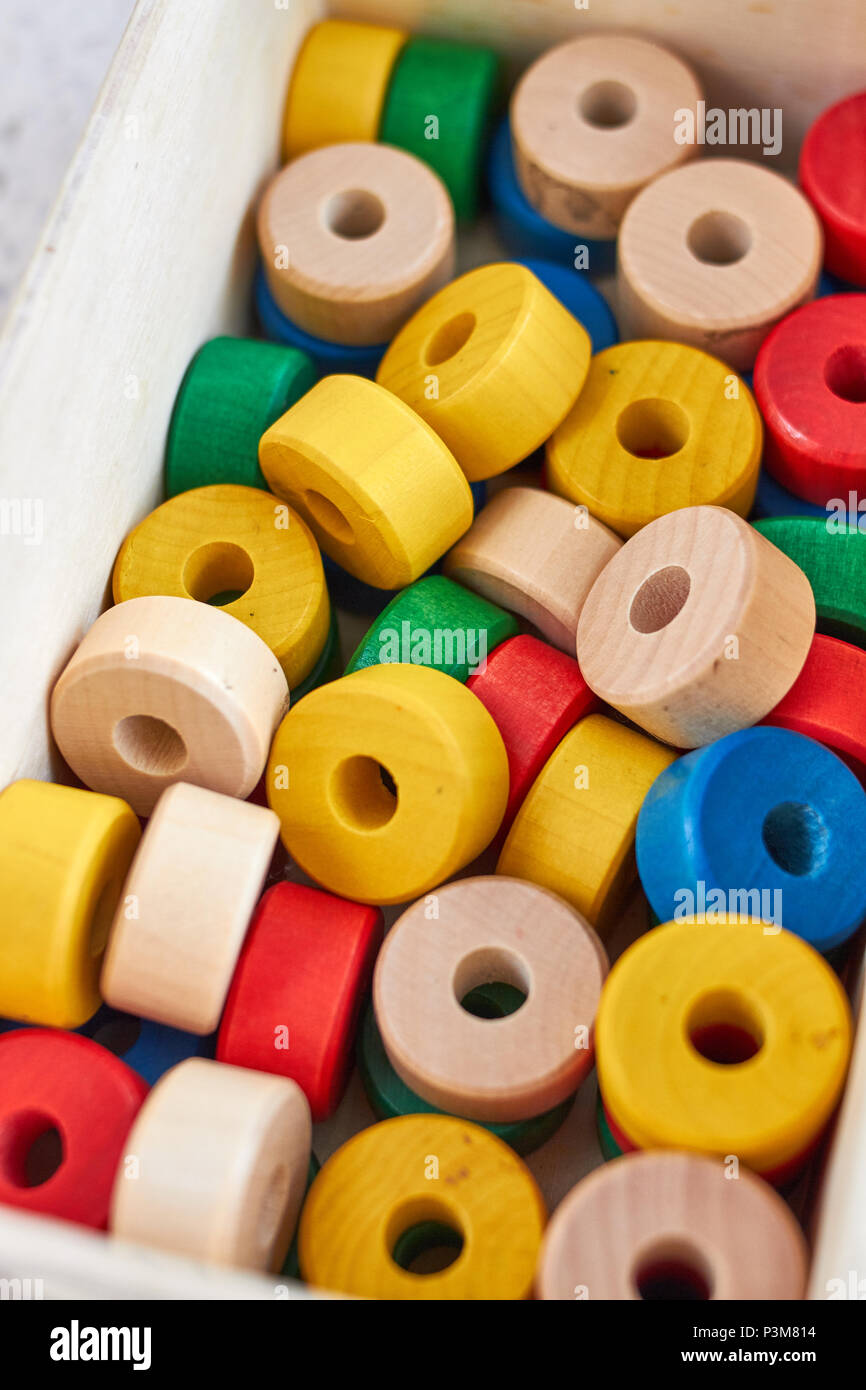 Set of colorful wooden cylinders for sewing at school Stock Photo Alamy