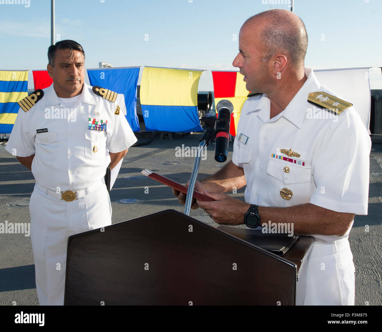 SAN DIEGO (July 5, 2016) Rear Adm. James Kilby, Commander, Naval Surface and Mine Warfare Development Center, right, presents Mexican navy Capt. Sergio Serrallonga Sanchez, Commander, Naval Flotilla of Destroyers of Pacific Naval Forces, left, with a plaque commemorating the two countries’ partnership as part of the Southern California portion of the Rim of the Pacific (RIMPAC) 2016 exercise during a reception aboard the Mexican navy tank landing ship ARM Usumacinta (A-412). Twenty-six nations, more than 40 ships and submarines, more than 200 aircraft and 25,000 personnel are participating in  Stock Photo