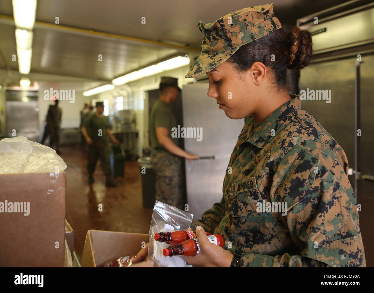 160710-N-ND246-006 POHAKULOA TRAINING AREA, Hawaii (July 10, 2016) – Lance Cpl. Alexis Walton empties a box at a mess hall in Pohakuloa Training Area, Hawaii, July 10, 2016, during Rim of the Pacific 2016. Twenty-six nations, 49 ships, six submarines, about 200 aircraft, and 25,000 personnel are participating in RIMPAC 2016 from June 29 to Aug. 4 in and around the Hawaiian Islands and Southern California. The world’s largest international maritime exercise, RIMPAC provides a unique training opportunity while fostering and sustaining cooperative relationships between participants critical to en Stock Photo