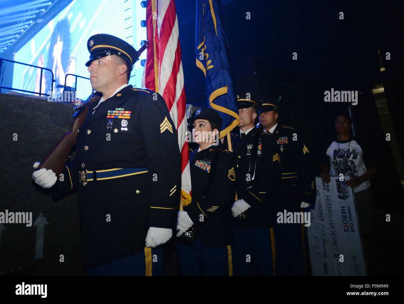 Members of the Oregon Army National Guard prepare to go on stage with the band KISS during the “Freedom to Rock” concert at Matthew Knight Arena in Eugene, Oregon, July 9, 2016. The Oregon National Guard Soldiers displayed the American flag while KISS performed the National Anthem and led the audience in the Pledge of Allegiance during a patriotic tribute to U.S. military and veterans at the concert. From left: Sgt. Jeffrey Cox, of Salem, with Detachment 1, Company A, 1-112th Aviation; Staff Sgt. Valerie Dean, of Salem, with Joint Force Headquarters; Sgt. Jerald Bone, of Newport, with Detachme Stock Photo
