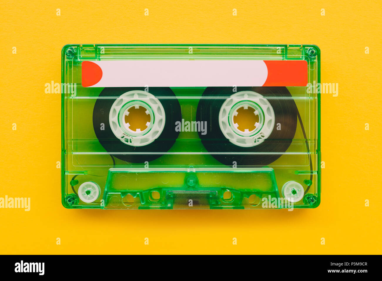 Audio cassette tape on yellow background with copy space, feeling nostalgia for retro vintage technology Stock Photo