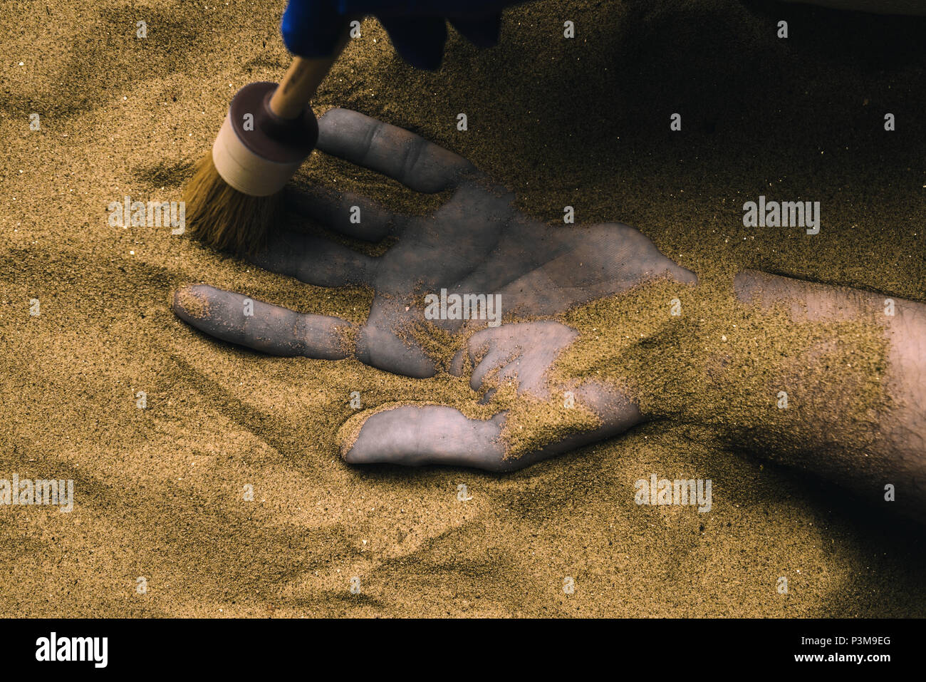 Forensic expert discovering dead body buried in desert sand. Conceptual image for police investigation of an cold case murder crime scene. Stock Photo