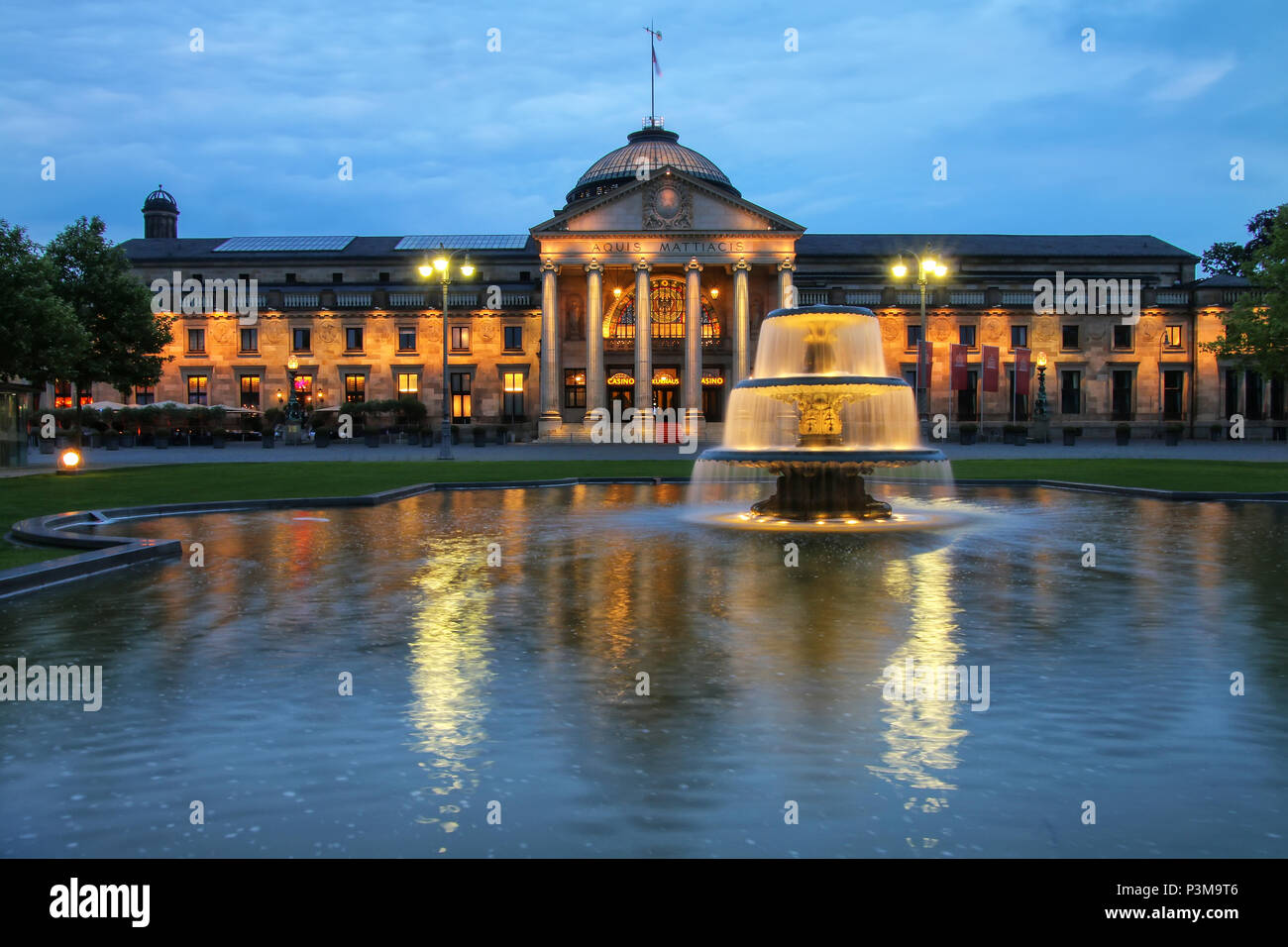 Kurhaus and Bowling Green in the evening with lights, Wiesbaden, Hesse, Germany. Wiesbaden is one of the oldest spa towns in Europe Stock Photo