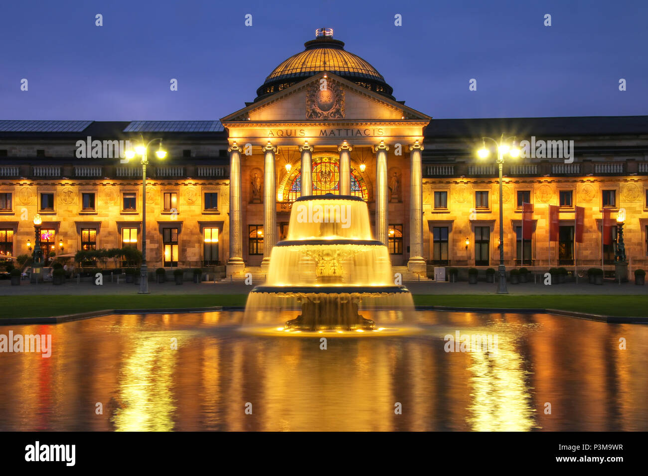 Kurhaus and Bowling Green in the evening with lights, Wiesbaden, Hesse, Germany. Wiesbaden is one of the oldest spa towns in Europe Stock Photo