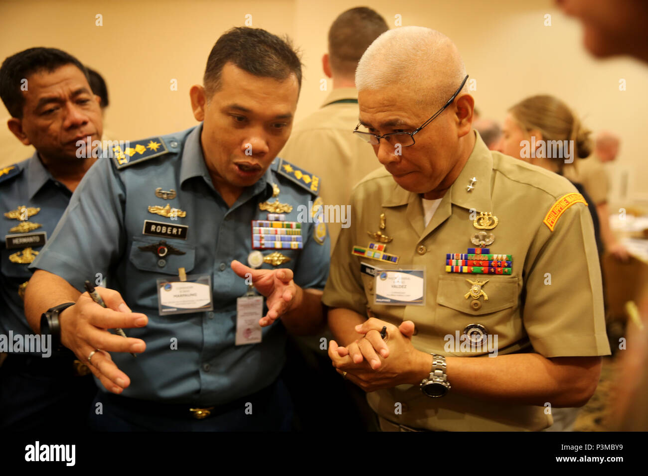 SAN DIEGO, Calif. - Indonesian Commander Robert Marpaung, Staf Perwira Kerjasama Internasional V/ Strategi Operasi, Staf Operasi, Mabes TNI AL, and Major General Remigo Castro Valdez, commandant of the Philippine Marine Corps, interact with one another during a Table-Top Exercise, as part of Pacific Command Amphibious Leaders Symposium 2016 (PALS-16) in San Diego, Calif., July 12, 2016. PALS-16 brings together senior leaders of allied and partner nations throughout the Indo-Asia Pacific region. The symposium consists of academic and group discussions, a Table-Top Exercise and an amphibious lan Stock Photo