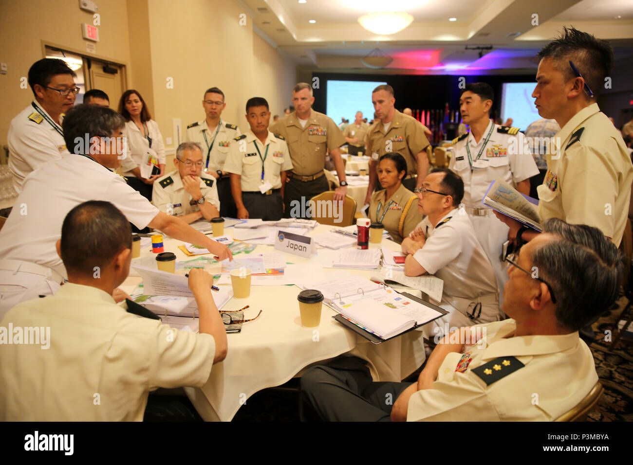 SAN DIEGO, Calif. - Service members from the United States and Japan come together in order to discuss potential strategies for responding to relief during a Table-Top Exercise, as part of Pacific Command Amphibious Leaders Symposium 2016 (PALS-16) in San Diego, Calif., July 12, 2016. PALS-16 is one of the many events the Marine Corps participates in to strengthen interoperability and working relationships across a wide range of operations. Senior military leaders from many nations will use PALS as a platform to build upon already established military-to-military relationships as well as hone Stock Photo