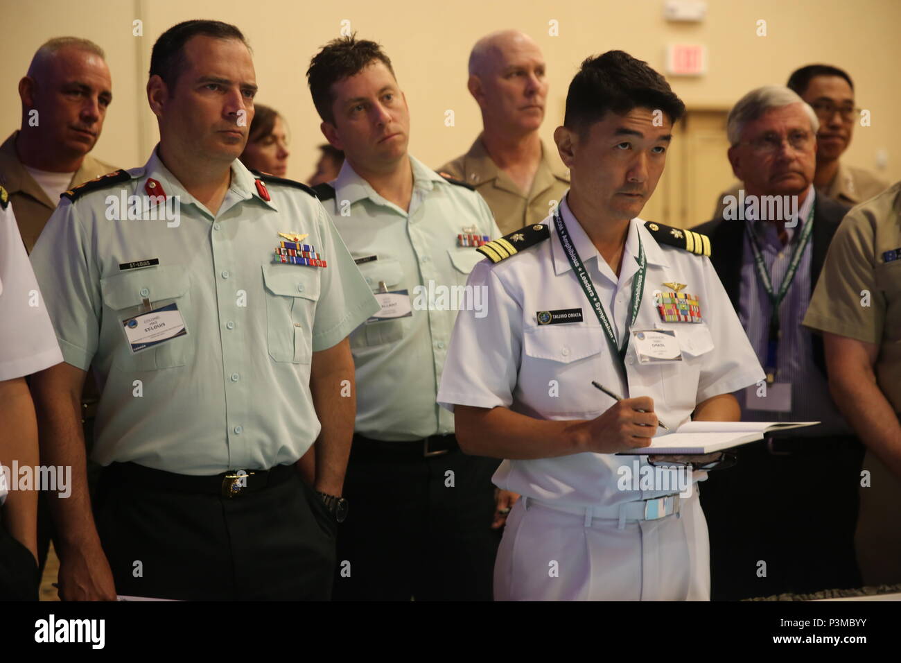 SAN DIEGO Calif. - Service members with Canada, United States and Japan observe strategies presented during a Table-Top Exercise, as part of Pacific Command Amphibious Leaders Symposium 2016 (PALS-16) in San Diego, Calif., July 12, 2016. PALS-16 provides senior military leaders with a platform to interact with one another while discussing various ways to conduct military operations. This dialog is important to inform one another of the many different capabilities each nation has to offer to support potential missions and objectives. (U.S. Marine Corps photo by Cpl. Demetrius Morgan/ RELEASED) Stock Photo