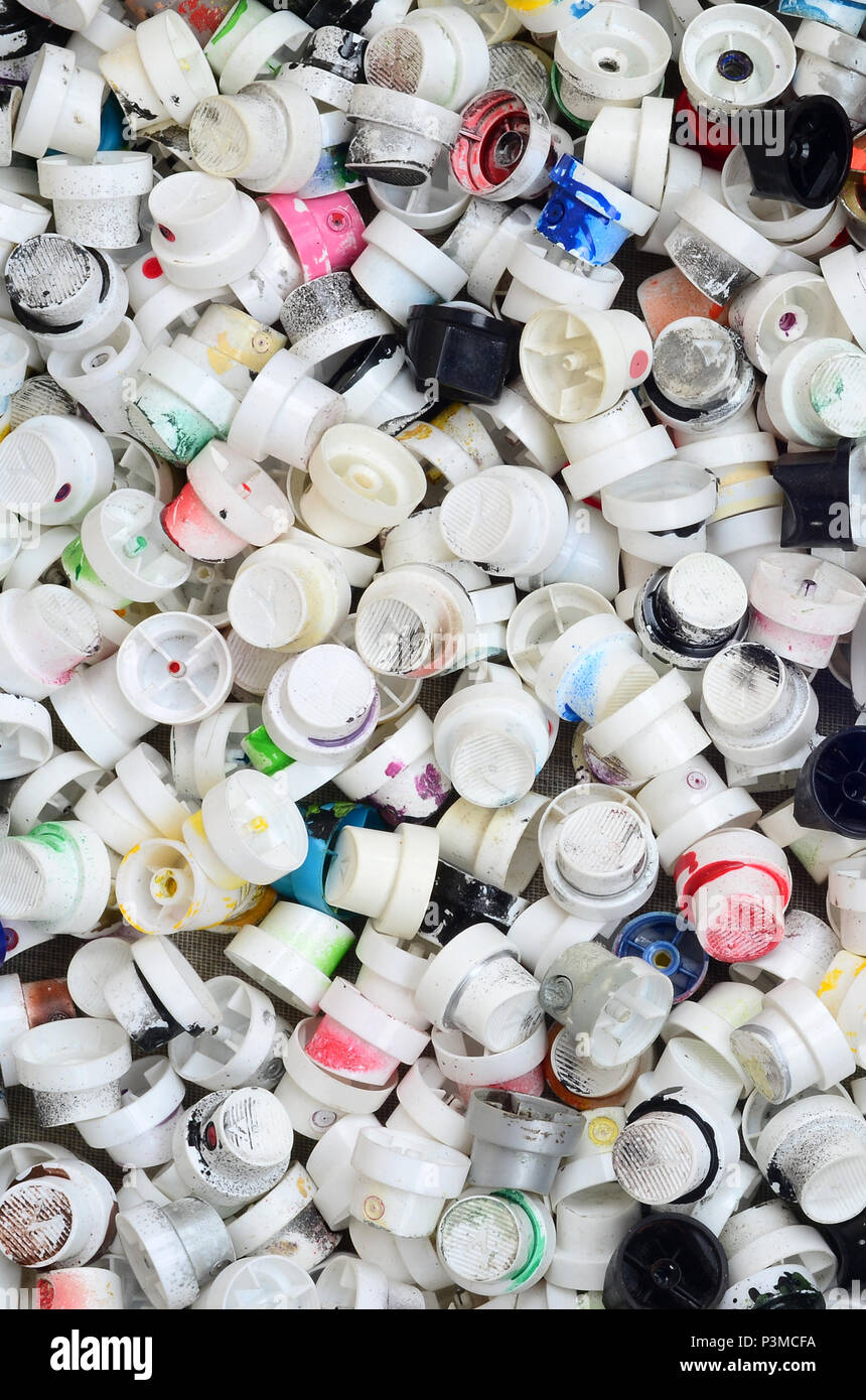 A pattern of many used and soiled nozzles from spray cans with aerosol