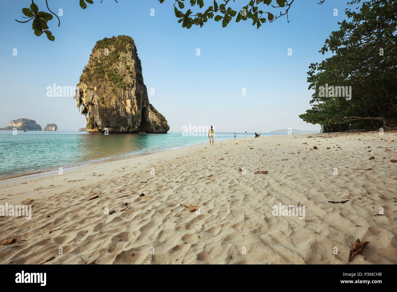 KRABI, THAILAND - CIRCA MAR 2013: Krabi province in Thailand. The beautiful beaches of Railay. Tourists went for a walk early in the morning Stock Photo