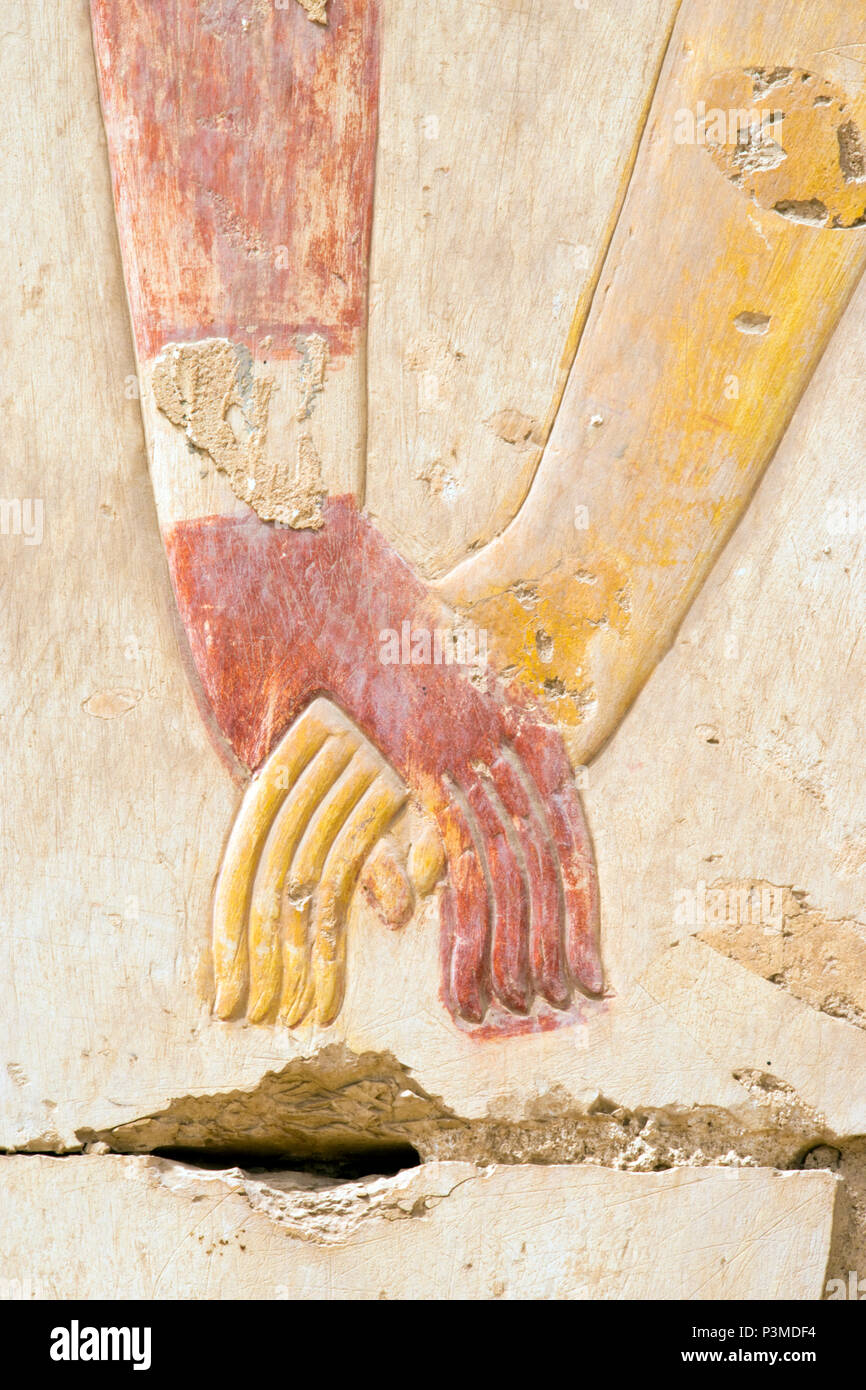Colorfully painted bas relief stone carvings of a king and queen holding  hands at the Great Osiris Temple, Abydos, Egypt Stock Photo - Alamy