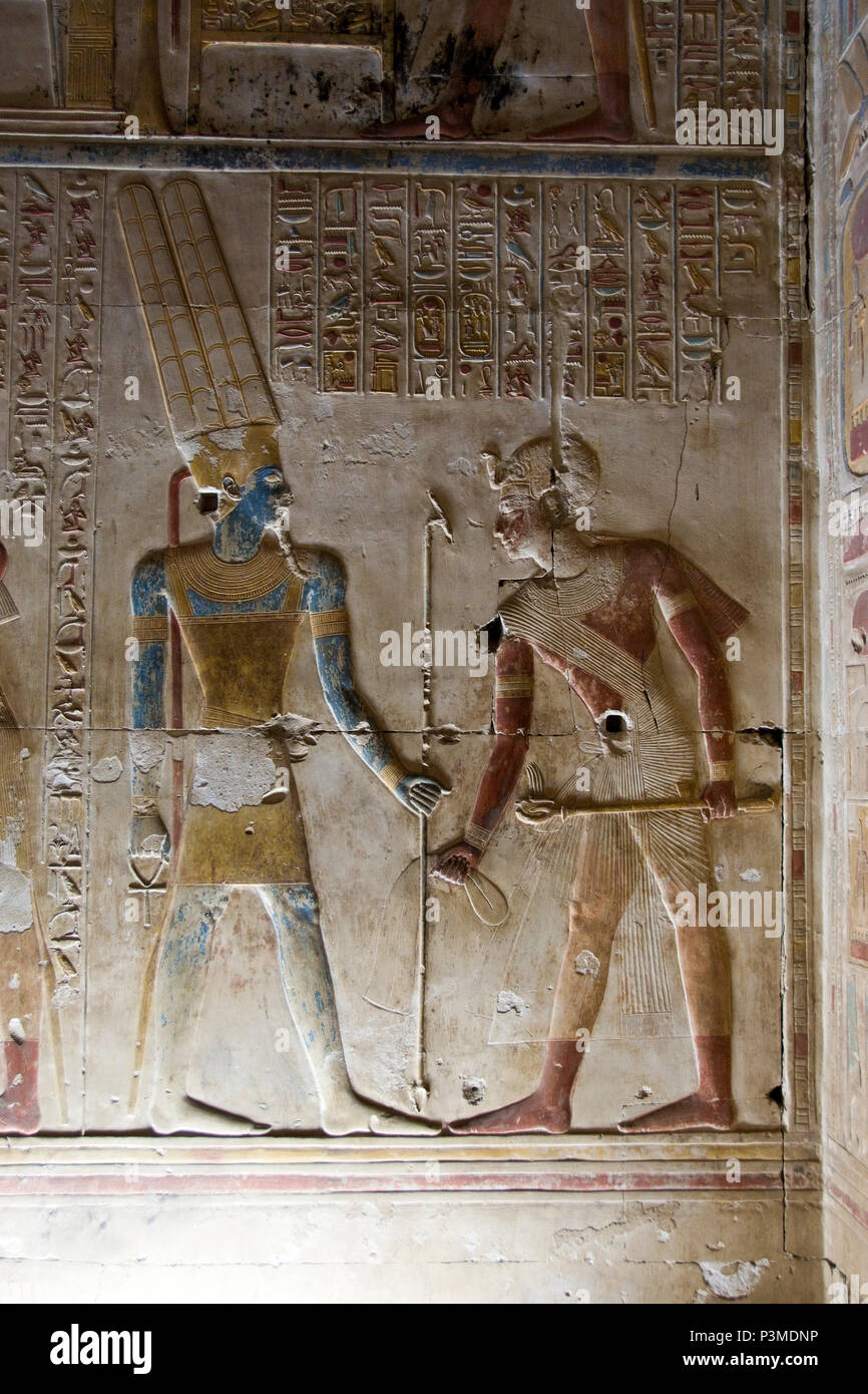 Bas relief carvings depict Pharaoh and the Egyptian gods inside the Great Osiris Temple built by Pepi I, Abydos, Egypt. Stock Photo