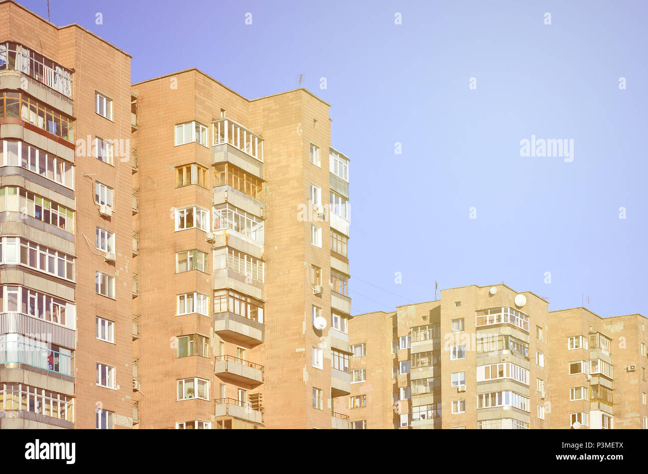 Detailed photo of multi-storey residential building with lots of balconies and windows. Hostels for poor people in Russia and Ukraine in a damaged con Stock Photo