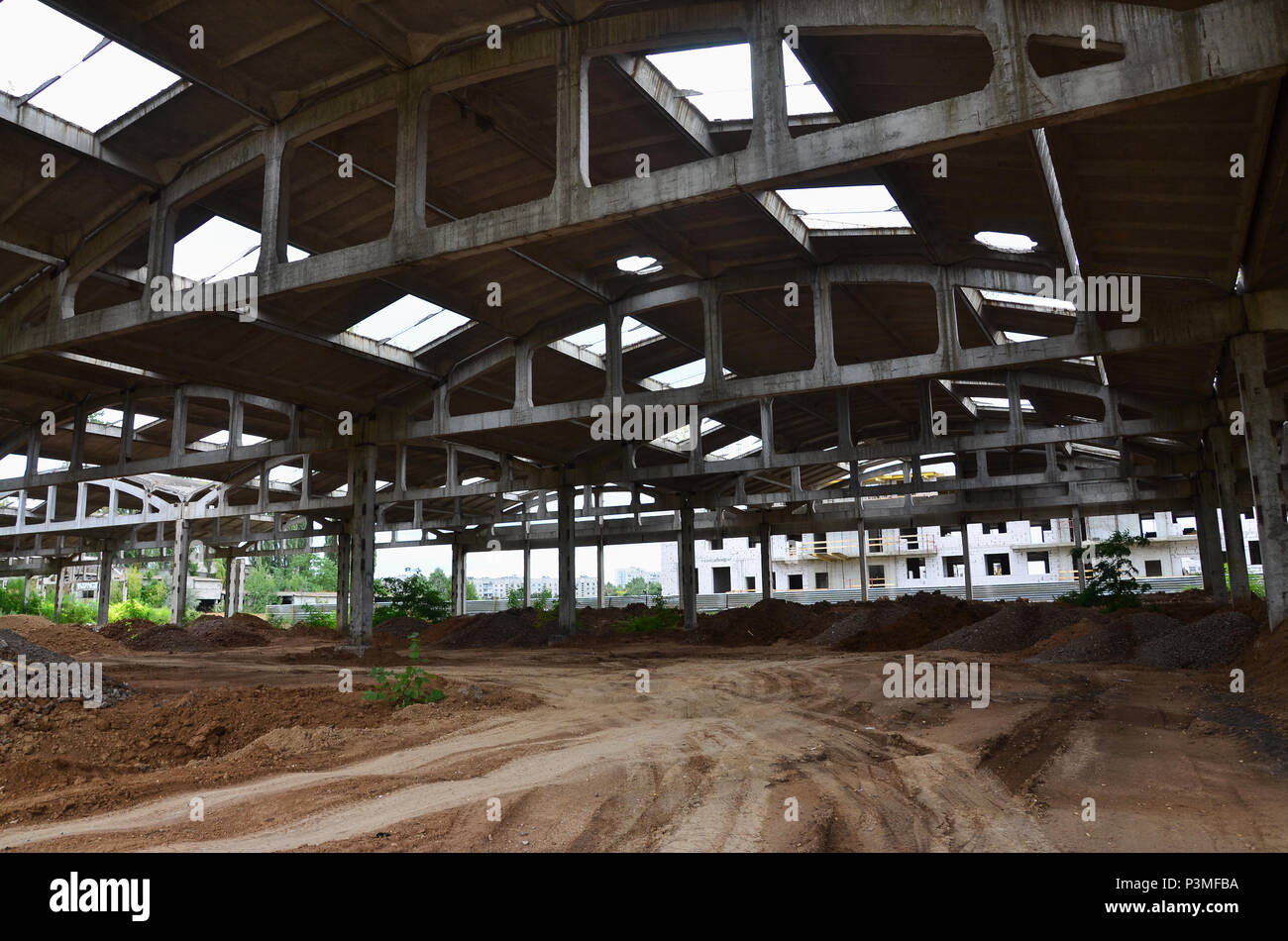 Landscape image of an abandoned industrial hangar with a damaged roof. Photo on wide-angle lens Stock Photo
