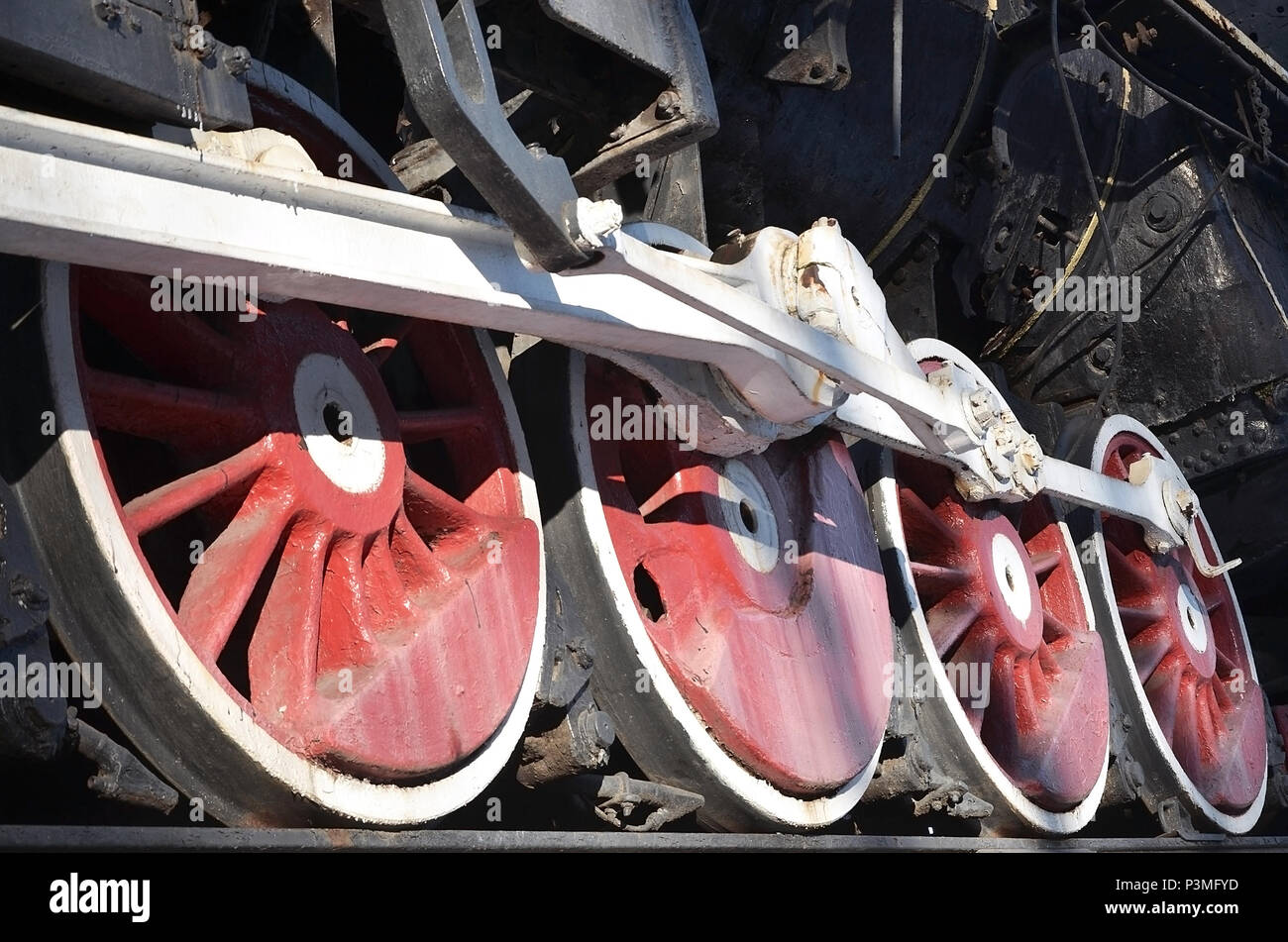 Red wheels of old USSR black steam locomotive. Wheels of an old soviet ...