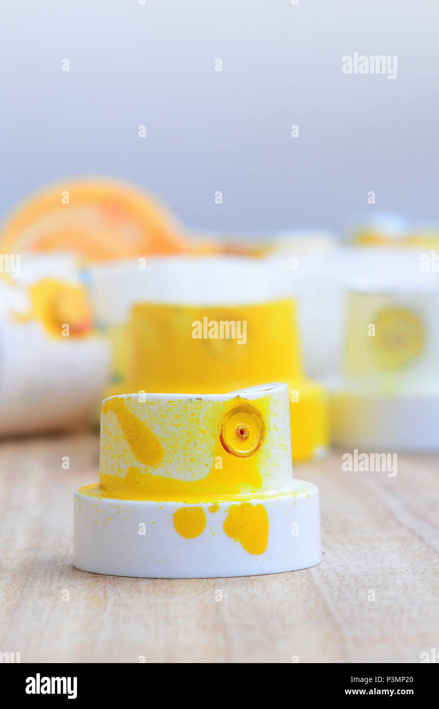 Download Several Plastic Nozzles From A Paint Sprayer That Lie On A Wooden Surface Against A Gray Wall Background The Caps Are Smeared In Yellow Paint The Co Stock Photo Alamy Yellowimages Mockups