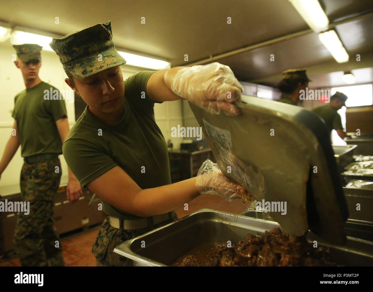 160710-N-ND246-0010 POHAKULOA TRAINING AREA, Hawaii (July 10, 2016) – Lance Cpl. Erika Vargas empties a bag of food into a serving dish at a mess hall in Pohakuloa Training Area, Hawaii, July 10, 2016, during Rim of the Pacific 2016. Twenty-six nations, 49 ships, six submarines, about 200 aircraft, and 25,000 personnel are participating in RIMPAC 16 from June 29 to Aug. 4 in and around the Hawaiian Islands and Southern California. The world’s largest international maritime exercise, RIMPAC provides a unique training opportunity while fostering and sustaining cooperative relationships between p Stock Photo