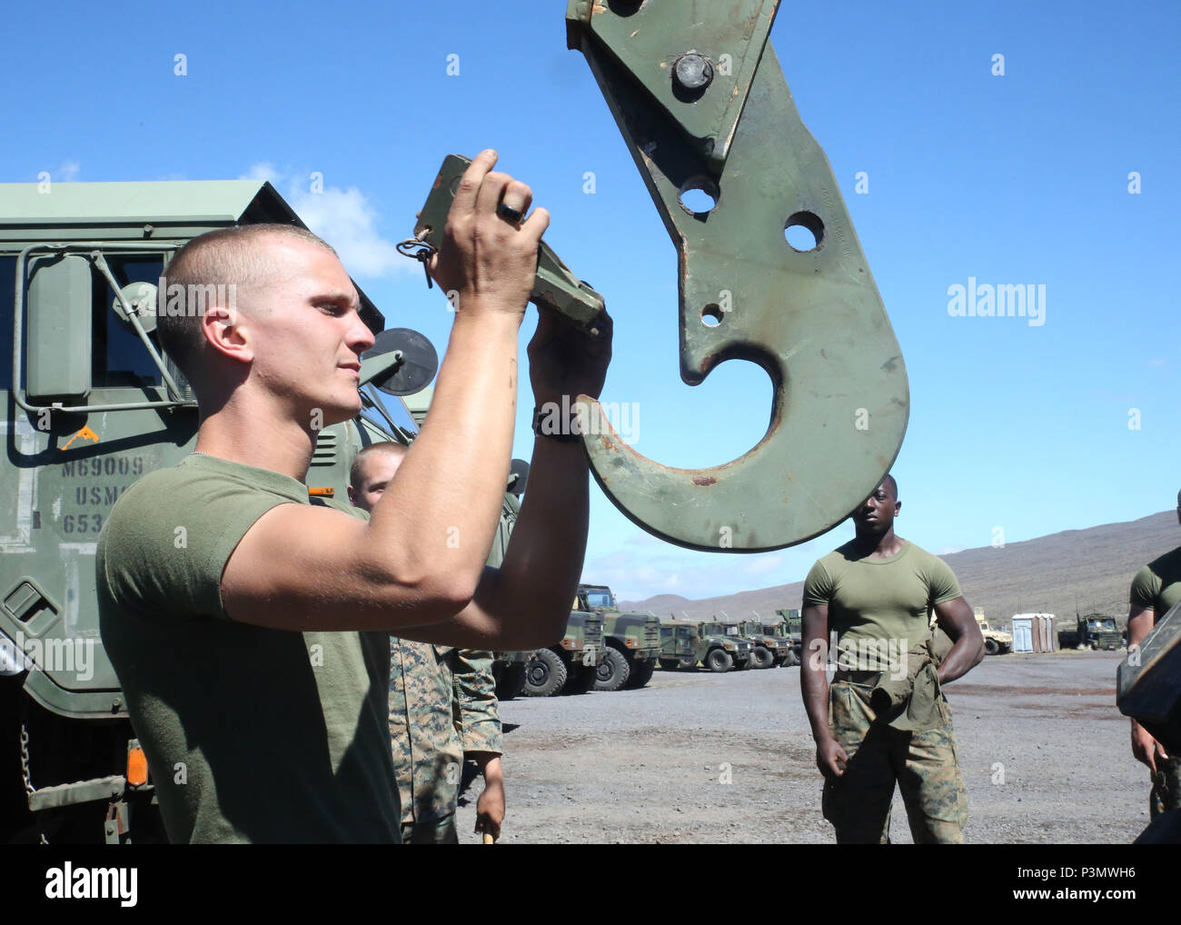 160711-N-ND864-005 POHAKULOA TRAINING AREA, Hawaii (July 11, 2016) – Pfc. Jacob White prepares a Logistics Vehicle System Replacement to be loaded at a motor pool at the Pohakuloa Training Area, Hawaii, July 11, 2016, during Rim of the Pacific 2016. Twenty-six nations, 49 ships, six submarines, about 200 aircraft, and 25,000 personnel are participating in RIMPAC 16 from June 29 to Aug. 4 in and around the Hawaiian Islands and Southern California. The world’s largest international maritime exercise, RIMPAC provides a unique training opportunity while fostering and sustaining cooperative relatio Stock Photo