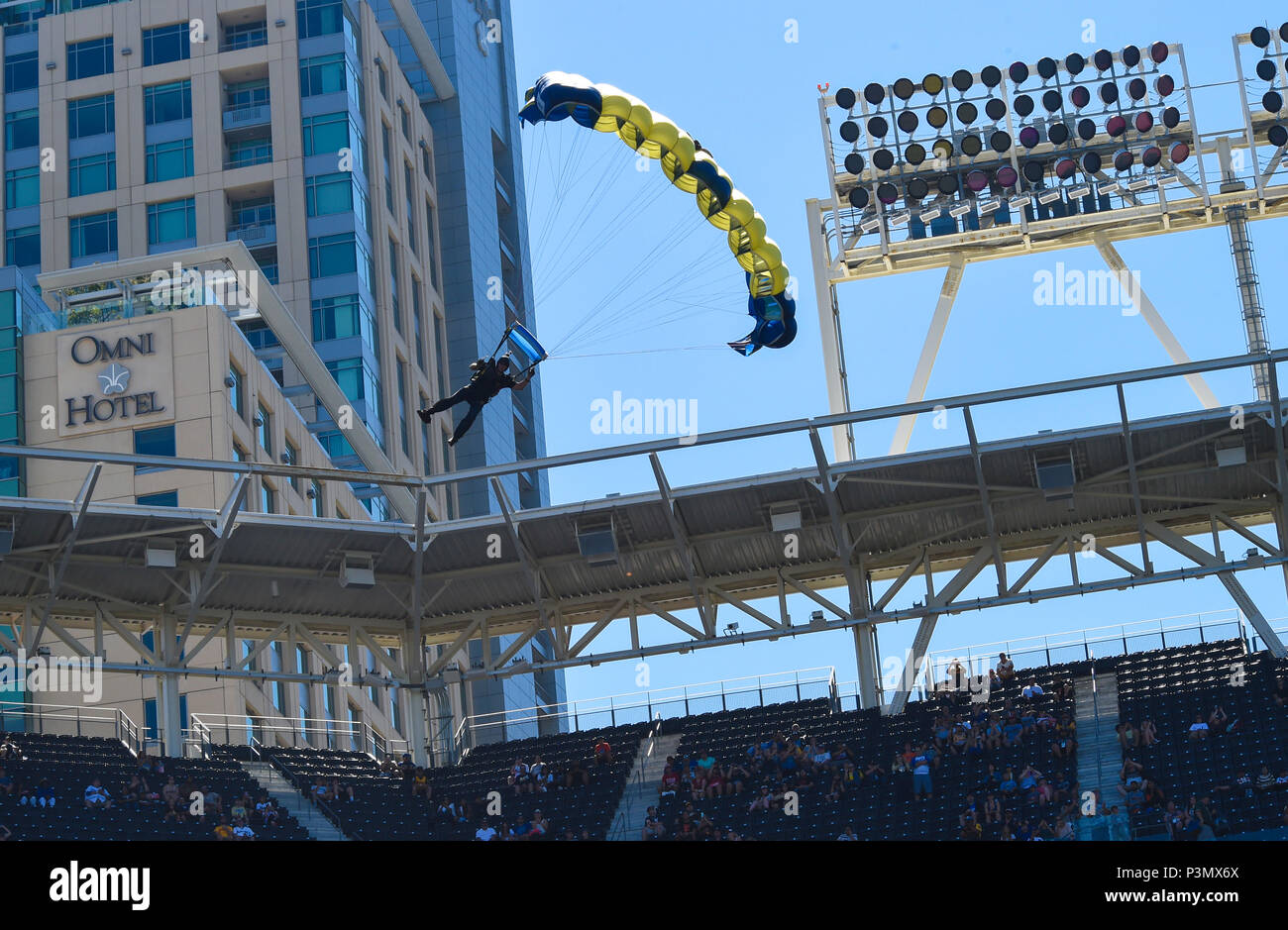160710-N-VY375-077 SAN DIEGO (July 10, 2016) – Retired U.S. Navy SEAL Jim Woods, member of the U.S. Navy Parachute Team, the Leap Frogs, prepares to land during a demonstration at the Major League Baseball All-Star Futures Game above Petco Park. The Navy Parachute Team is based in San Diego and performs aerial parachute demonstrations around the nation in support of Naval Special Warfare and Navy recruiting. (U.S. Navy photo by Special Operator 1st Class Remington Peters/Released) Stock Photo