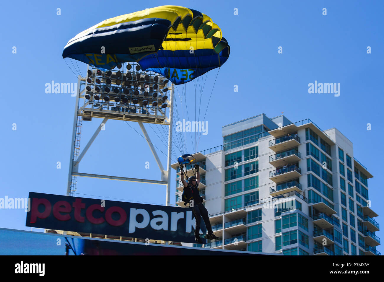 160710-N-VY375-017 SAN DIEGO (July 10, 2016) – Lt. (SEAL) Duncan Hamilton, member of the U.S. Navy Parachute Team, the Leap Frogs, comes in for a landing during a demonstration at the Major League Baseball All-Star Futures Game above Petco Park. The Navy Parachute Team is based in San Diego and performs aerial parachute demonstrations around the nation in support of Naval Special Warfare and Navy recruiting. (U.S. Navy photo by Special Operator 1st Class Remington Peters/Released) Stock Photo