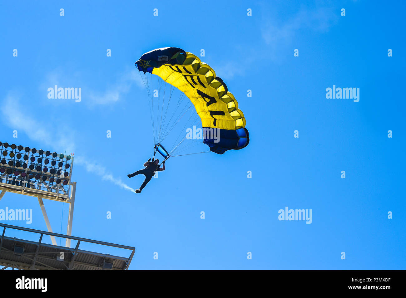 160710-N-VY375-013 SAN DIEGO (July 10, 2016) – Lt. (SEAL) Duncan Hamilton, member of the U.S. Navy Parachute Team, the Leap Frogs, prepares to land during a demonstration at the Major League Baseball All-Star Futures Game above Petco Park. The Navy Parachute Team is based in San Diego and performs aerial parachute demonstrations around the nation in support of Naval Special Warfare and Navy recruiting. (U.S. Navy photo by Special Operator 1st Class Remington Peters/Released) Stock Photo
