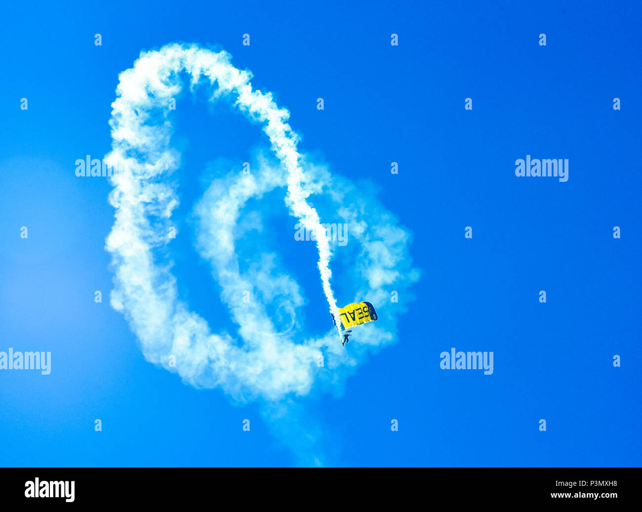 160710-N-VY375-002 SAN DIEGO (July 10, 2016) – Lt. (SEAL) Duncan Hamilton, member of the U.S. Navy Parachute Team, the Leap Frogs, trails smoke during a demonstration at the Major League Baseball All-Star Futures Game above Petco Park. The Navy Parachute Team is based in San Diego and performs aerial parachute demonstrations around the nation in support of Naval Special Warfare and Navy recruiting. (U.S. Navy photo by Special Operator 1st Class Remington Peters/Released) Stock Photo