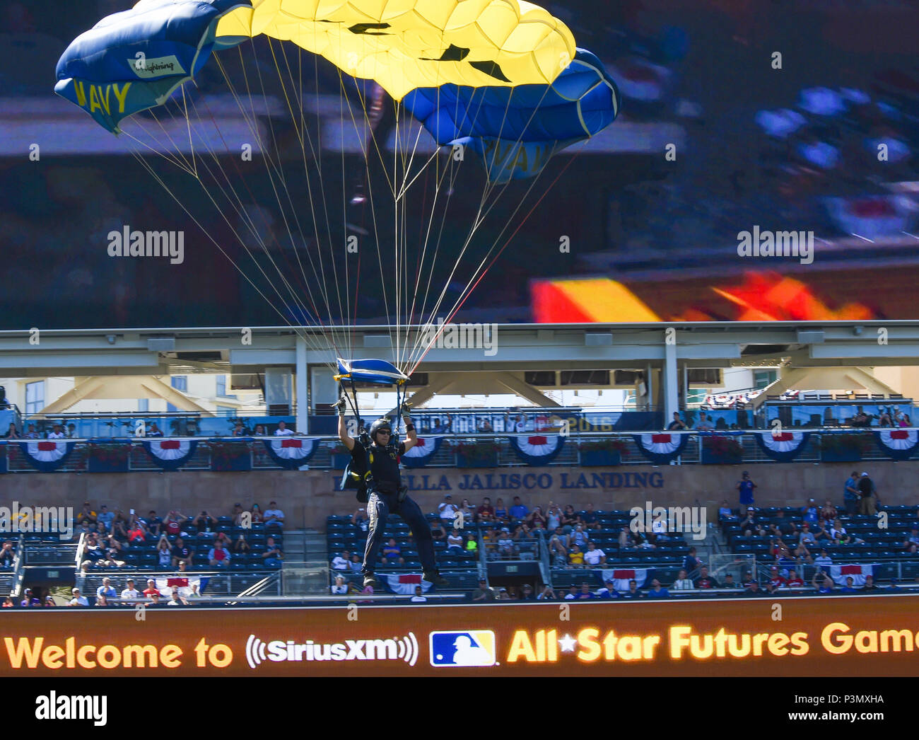 160710-N-VY375-058 SAN DIEGO (July 10, 2016) – Aircrew Survival Equipmentman 1st Class Victor Maldonado, member of the U.S. Navy Parachute Team, the Leap Frogs, prepares to land during a demonstration at the Major League Baseball All-Star Futures Game above Petco Park. The Navy Parachute Team is based in San Diego and performs aerial parachute demonstrations around the nation in support of Naval Special Warfare and Navy recruiting. (U.S. Navy photo by Special Operator 1st Class Remington Peters/Released) Stock Photo