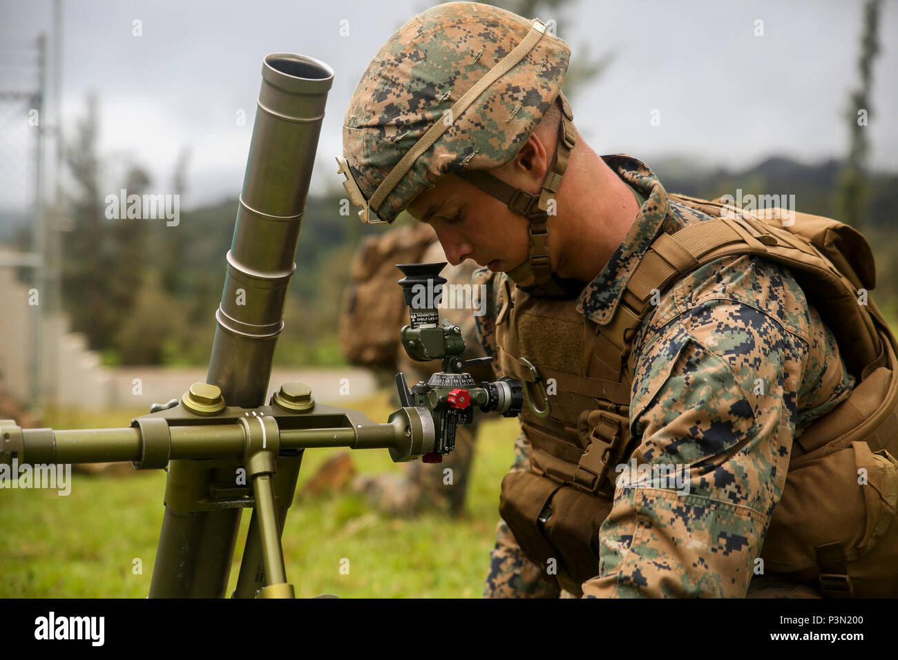 160714-M-JM737-051 KAHUKU TRAINING AREA, Hawaii (July 13, 2016) -  A U.S. Marine Mortarman of Golf Company, 2nd Battalion, 3rd Marines, makes adjustments to the mortar as coordinates are called out to him during Rim of the Pacific 2016. Twenty-six nations, 49 ships, six submarines, about 200 aircraft, and 25,000 personnel are participating in RIMPAC 16 from June 29 to Aug. 4 in and around the Hawaiian Islands and Southern California. The world’s largest international maritime exercise, RIMPAC provides a unique training opportunity while fostering and sustaining cooperative relationships betwee Stock Photo