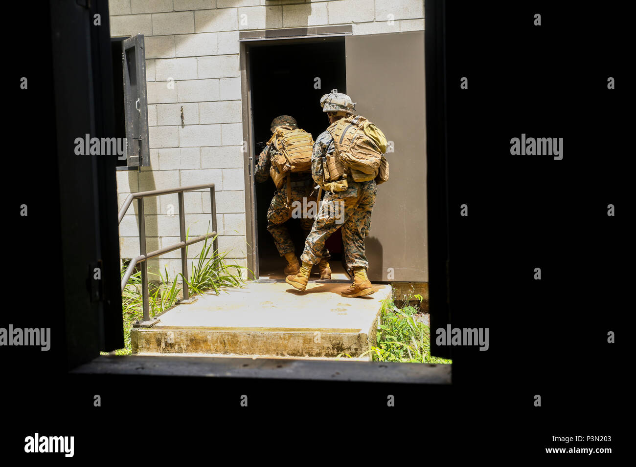 160714-M-JM737-058 KAHUKU TRAINING AREA, Hawaii (July 13, 2016) - U.S. Marines of Golf Company, 2nd Battalion, 3rd Marines, breach the door of their objective as part of a raid during Rim of the Pacific 2016. Twenty-six nations, 49 ships, six submarines, about 200 aircraft, and 25,000 personnel are participating in RIMPAC 16 from June 29 to Aug. 4 in and around the Hawaiian Islands and Southern California. The world’s largest international maritime exercise, RIMPAC provides a unique training opportunity while fostering and sustaining cooperative relationships between participants critical to e Stock Photo