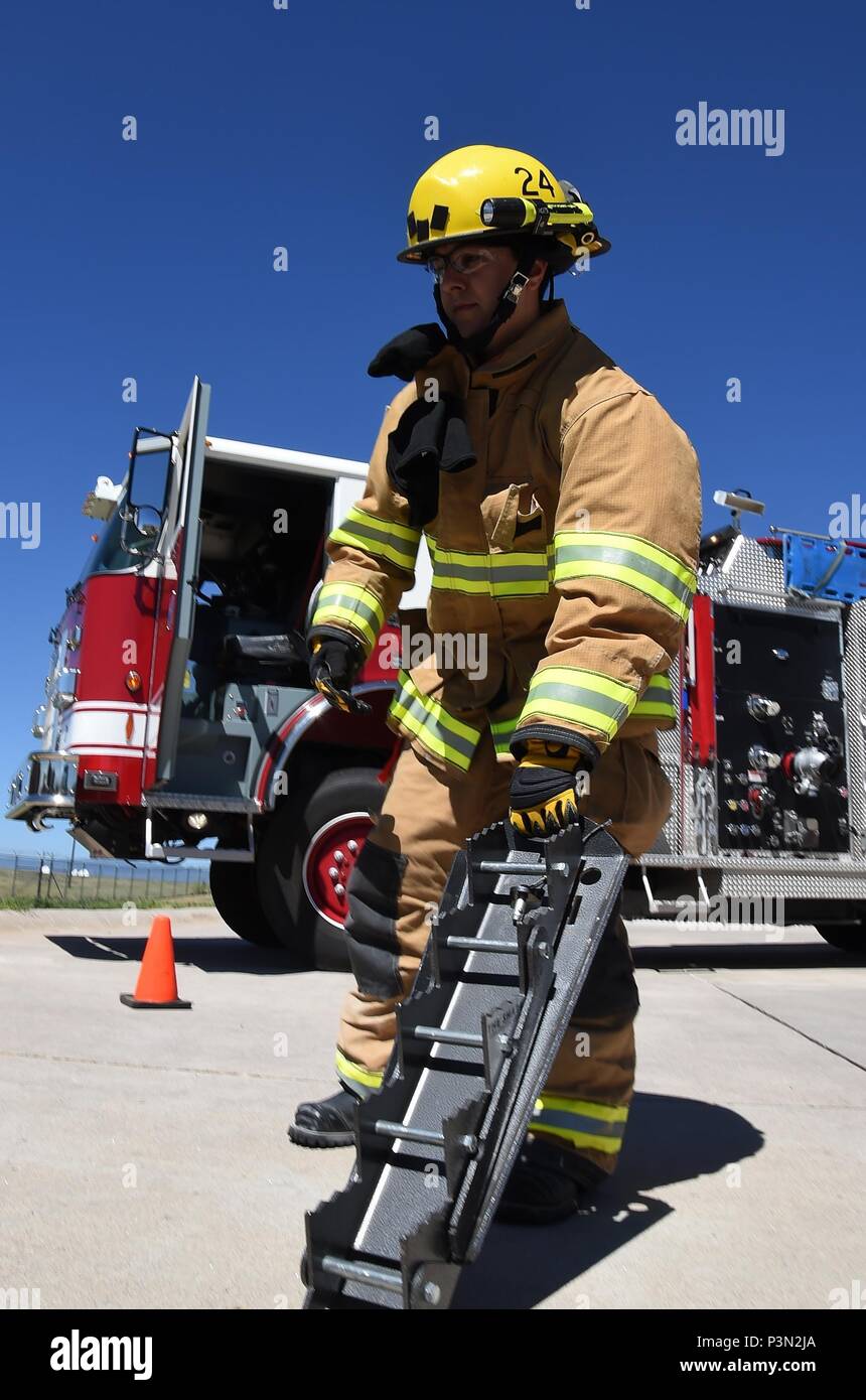 Kenny Gestes, Schriever Air Force Base Fire Department firefighter, handles  the Shark, a collapsible step cribbing, which is used to stabilize,  extricate, and rescue accident victims during a simulated emergency at  Schriever