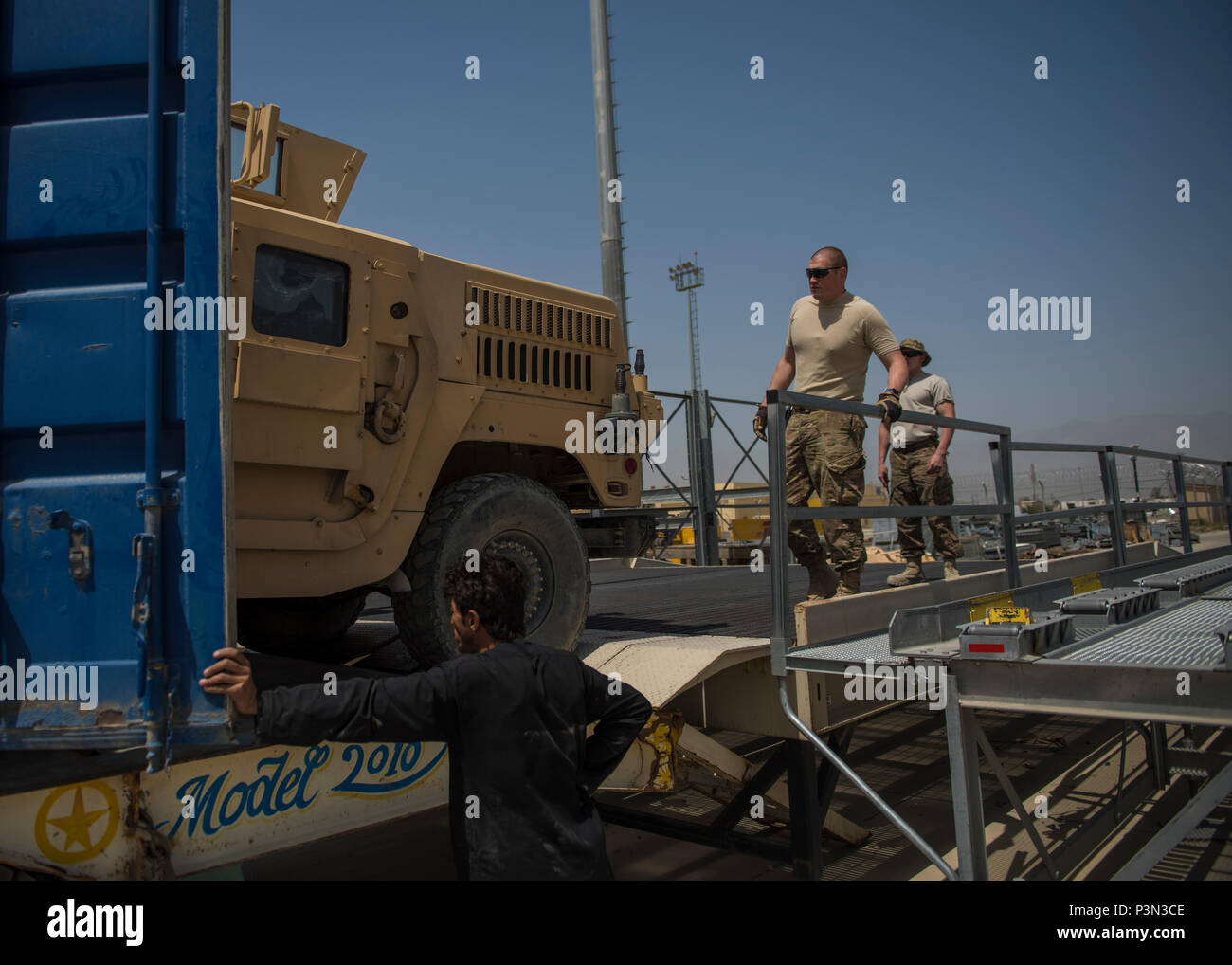 Tech Sgt. Richard Gadberry, 455th Expeditionary Logistics Readiness Squadron Central Command material recovery element, guides a high mobility multipurpose wheeled vehicle out of a container, July 14, 2016, Bagram Airfield, Afghanistan. Members of the 455th ELRS CMRE team went down to Hamid Karzai International Airport, Kabul to load up two retrograde HMMWVs to be shipped back to Bagram vehicle maintenance inspection. (U.S. Air Force photo by Senior Airman Justyn M. Freeman) Stock Photo