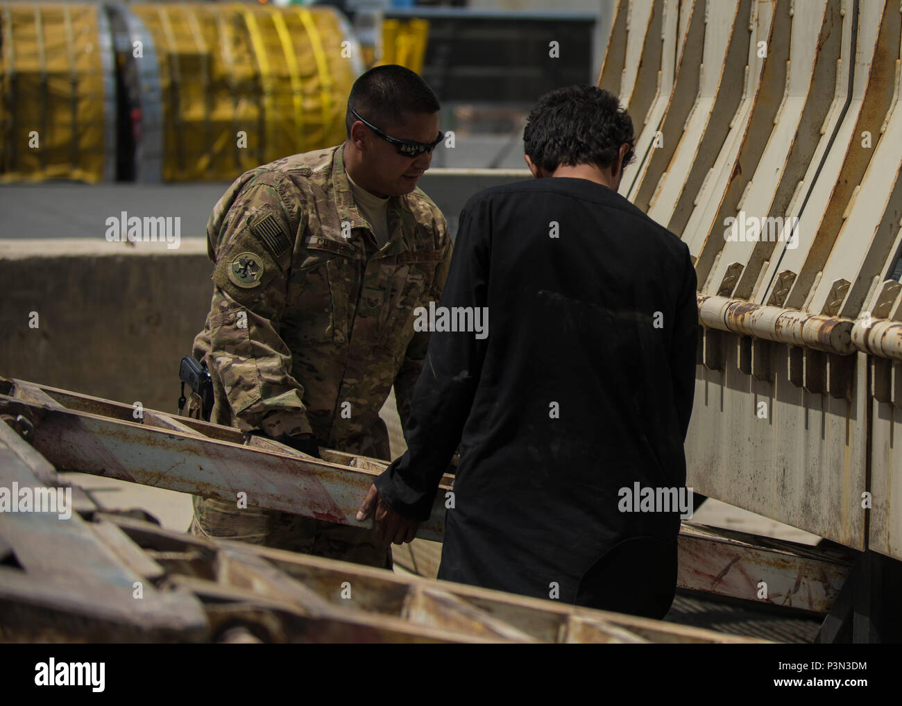 Staff Sgt. Jacob Chavez, 455th Expeditionary Logistics Readiness Squadron Central Command material recovery element, guides a vehicle ramp into place, July 14, 2016, Bagram Airfield, Afghanistan. The 455th ELRS CMRE team assesses and loads cargo, for future shipments. When dealing with retrograde HMMWVs, CMRE added a vehicle mechanic to their group to oversee the load. (U.S. Air Force photo by Senior Airman Justyn M. Freeman) Stock Photo